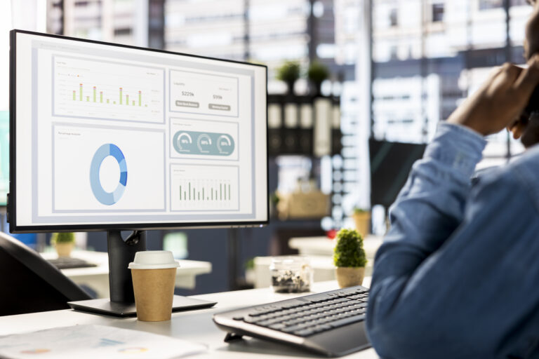 Businessman studying infographics and performance metrics